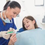Pediatric dental assistant and patient